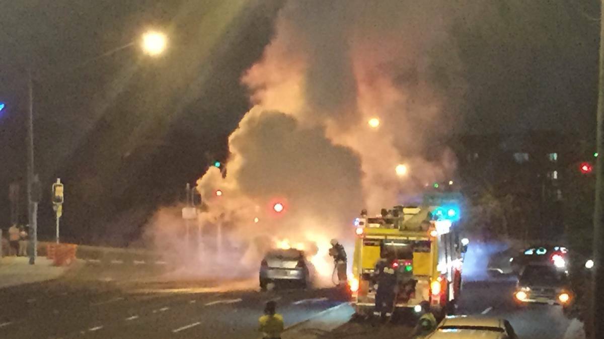 Emergency services personnel work to stop a car being on fire in Blacktown. Picture: Supplied