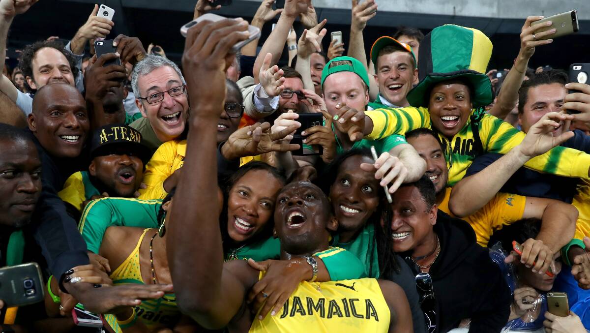 Usain Bolt of Jamaica celebrates with fans after winning the men's 200m final on Day 13. Photo: Ryan Pierse/Getty Images