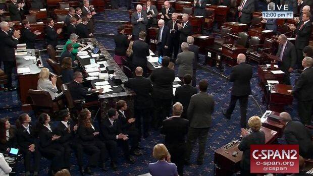 Senator John McCain is applauded as he arrives of the floor of the Senate on Capitol Hill in Washington. Photo: AP
