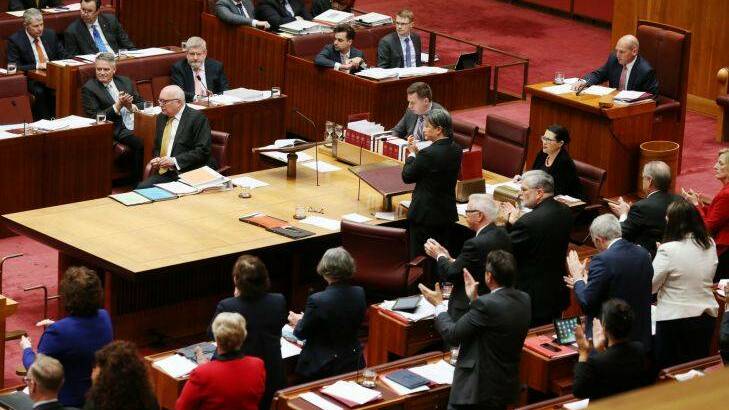 The Opposition praise Senator Brandis after he repudiated Senator Pauline Hanson for wearing a burqa during question time at Parliament House in Canberra on Thursday 17 August 2017. Fedpol. Photo: Andrew Meares