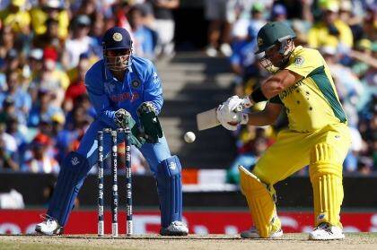 Cutting stroke: Australian batsman Aaron Finch plays a shot as India's captain MS Dhoni watches on. Photo: Reuters 