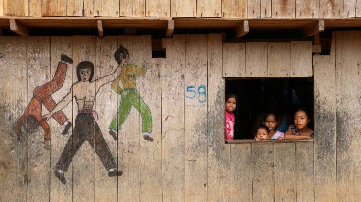 Children at a cut-out window next to kung fu drawings. Photo: Louise Southerden