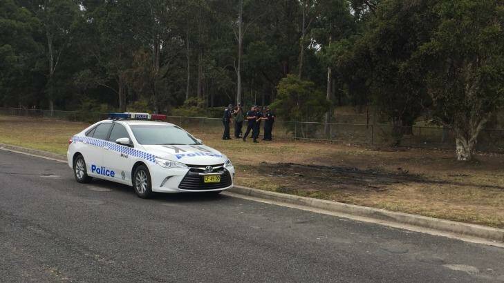 Police are searching an area in Sydney's south west after finding the burnt out car used in a fatal shooting this week.  Photo: Ava Benny-Morrison