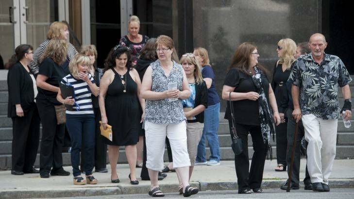 Victims and their families walk across the street from the federal courthouse after testimony was heard in the sentencing hearing of cancer doctor Farid Fata, Monday, July 6, 2015 in Detroit. (David Guralnick/Detroit News via AP) Photo: David Guralnick