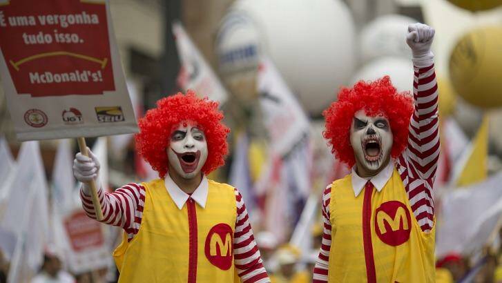 Demonstrators dressed as Ronald McDonald protest for better wages for McDonald's employees in Sao Paulo, Brazil.  Photo: Andre Penner