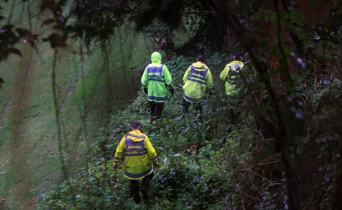 Officers examine the area surrounding a Mangerton unit where human remains were found on Thursday. Picture: SYLVIA LIBER