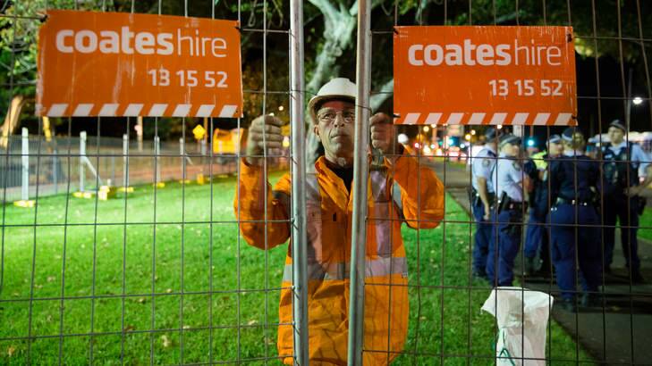 A fence is closed around Anzac Parade Moreton Bay fig trees scheduled for destruction to make room for the light rail. Photo: Janie Barrett