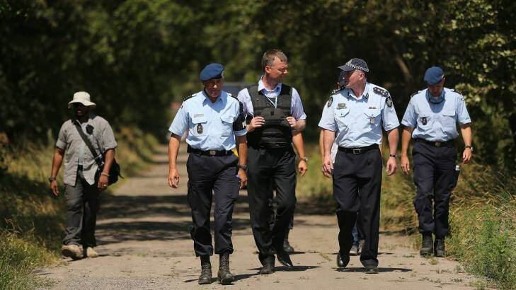 Australian Federal Police officer Brian McDonald (second from right) talks with his Dutch counterpart. Photo: Kate Geraghty