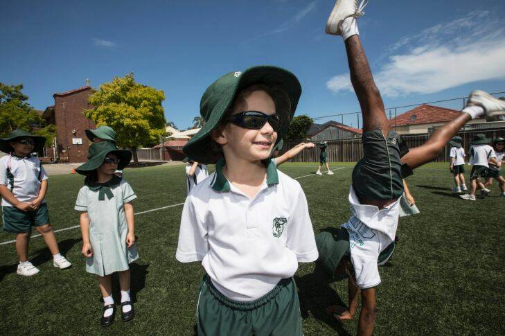 Alexia Challita is 6years old and is kindergarden at Lady of Fatima school, in Kingsford and is wearing the schools uniform sunglasses on 24 November 2017. The school has a strong sunsafety policy, even introducing sunglasses as an optional part of the school uniform last year. Photo: Jessica Hromas