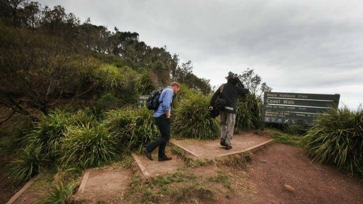 A news crew prepares to make the two-kilometre walk from Otford to Weerong beach, where a body was discovered nearby.  Photo: Kirk Gilmour