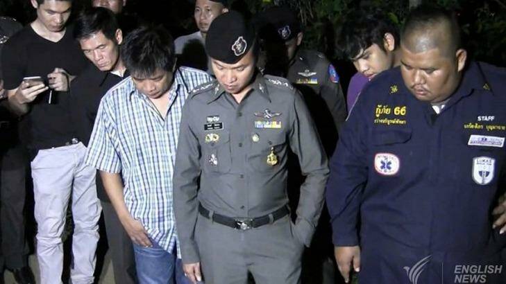 Police, paramedics and journalists surround Wayne Schneider's grave. Photo: Thai PBS English
