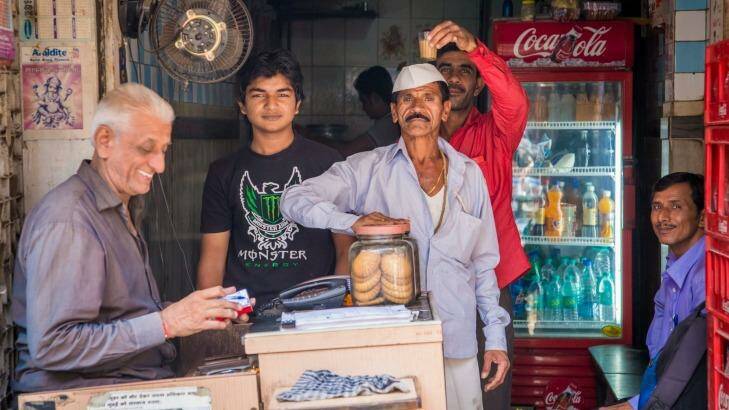 Street scene with men in front of small shop in Mumbai.  Photo: iStock