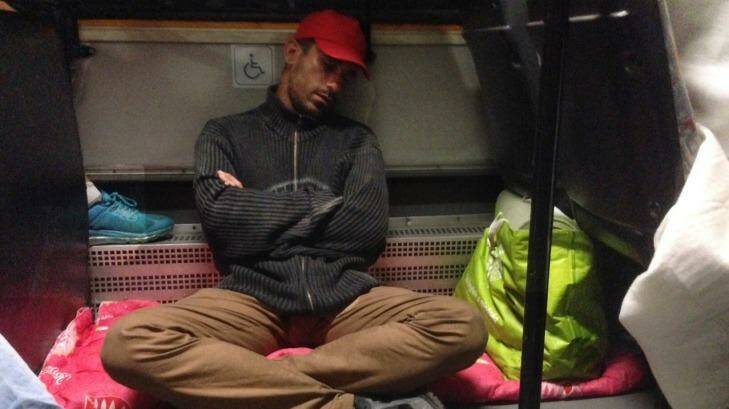 A migrant sleeps on the bus provided by Hungary to take hundreds of refugees away. Photo: David Maurice Smith
