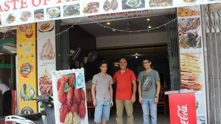 Hashim Farhan, 51, with his sons, Emad, 18, right, and Jassir, 22 at their restaurant in Phnom Penh. Photo: Sarah Whyte