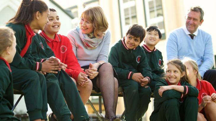 Maxine McKew, who wrote a book that examined the Australian education system, and principal John Farrell with students at Our Lady of Mount Carmel in Sydney's inner west last year.  Photo: Wolter Peeters