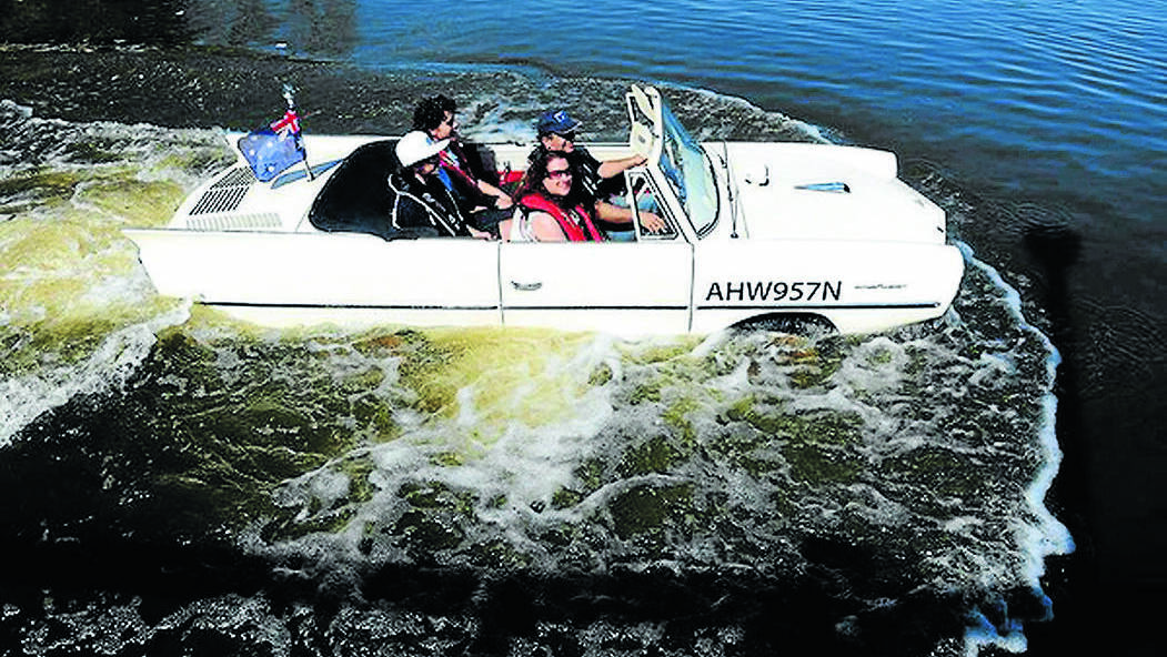 Tony Nassar on Lake Burley Griffin in his Amphicar with his wife Rebecca and their two sons back left, Andareas,15 and Jozeph, 17. Photo: Melissa Adams