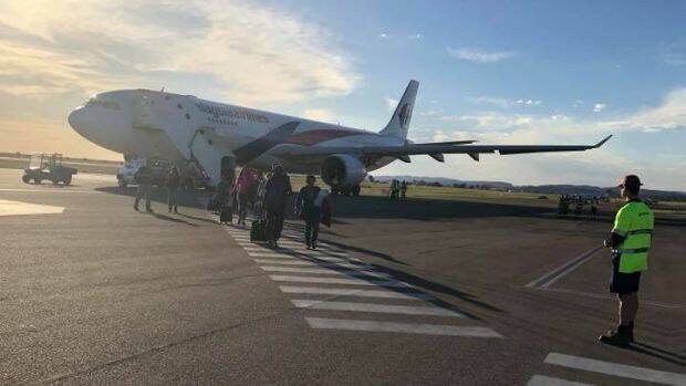 Passengers board flight MH122 in Sydney on Thursday. Photo: Sanjeev Pandey
