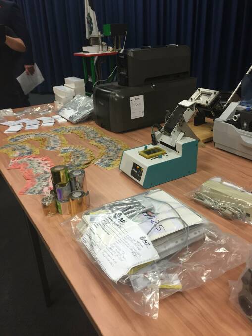 Big haul: Cash, licence holograms and blank cards were found during searches at Rockdale, Lakemba and Canley Vale on Wednesday. Picture: NSW Police Media.
