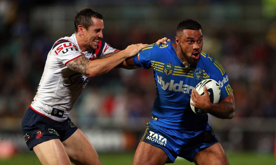 SYDNEY, AUSTRALIA - APRIL 12: Kenny Edwards of the Eels fends off the tackle by Mitchell Pearce during the round 6 NRL match between the Parramatta Eels and the Sydney Roosters at Pirtek Stadium on April 12, 2014 in Sydney, Australia. (Photo by Renee McKay/Getty Images)