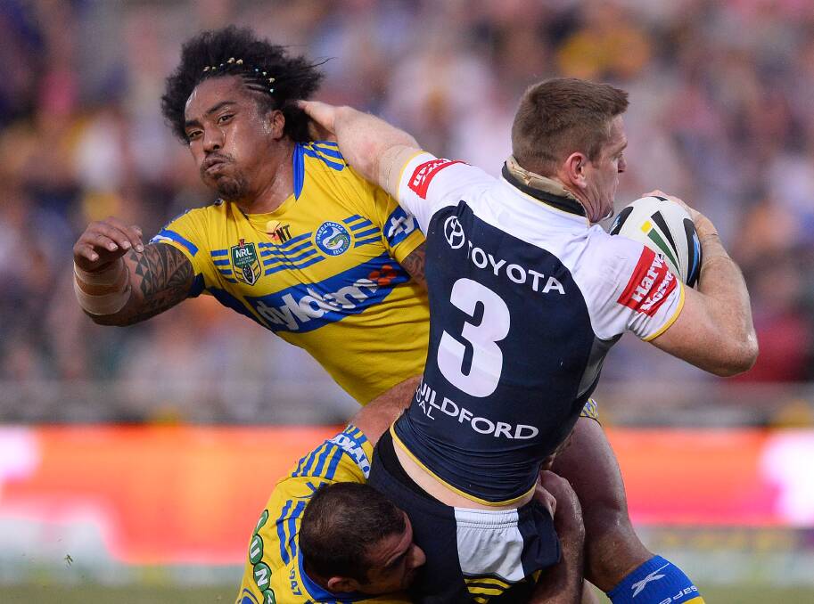TOWNSVILLE, AUSTRALIA - APRIL 26: Brent Tate of the Cowboys is tackled by Fuifui Moimoi and Tim Mannah of the Eels during the round 8 NRL match between the North Queensland Cowboys and the Parramatta Eels at 1300SMILES Stadium on April 26, 2014 in Townsville, Australia. (Photo by Ian Hitchcock/Getty Images)