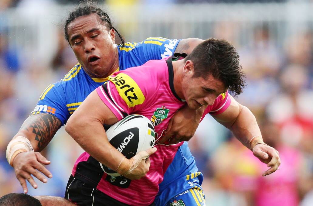 SYDNEY, AUSTRALIA - MARCH 29: Adam Docker of the Panthers is tackled by Fuifui Moimoi of the Eels during the round four NRL match between the Parramatta Eels and the Penrith Panthers at Pirtek Stadium on March 29, 2014 in Sydney, Australia. (Photo by Matt King/Getty Images)