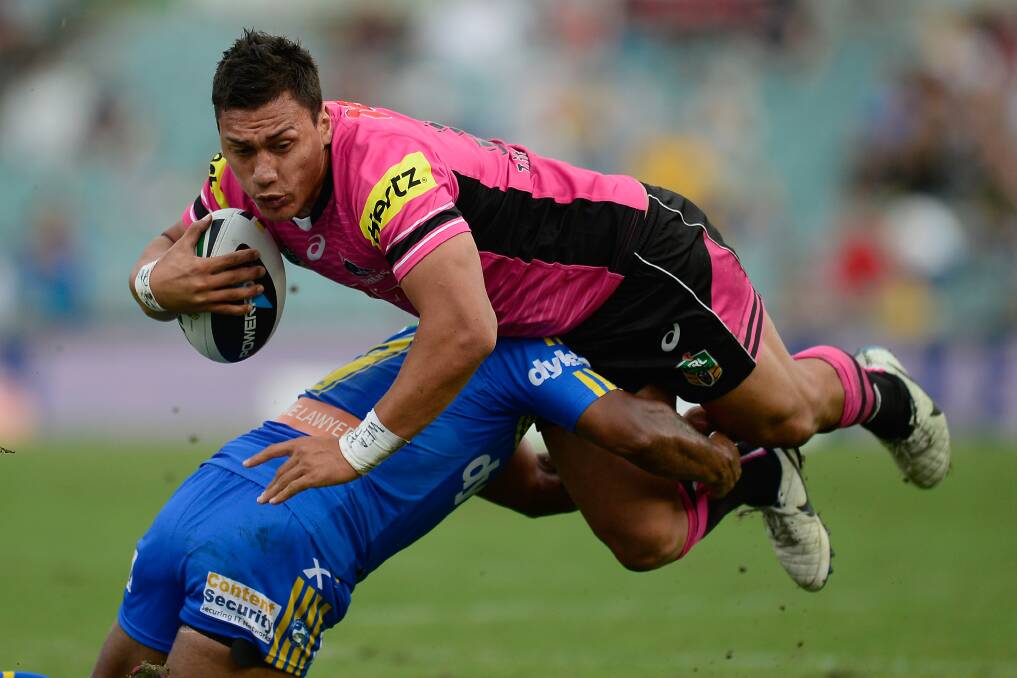 SYDNEY, AUSTRALIA - MARCH 29: Elijah Taylor of the Panthers is tackled during the round four NRL match between the Parramatta Eels and the Penrith Panthers at Pirtek Stadium on March 29, 2014 in Sydney, Australia. (Photo by Brett Hemmings/Getty Images)