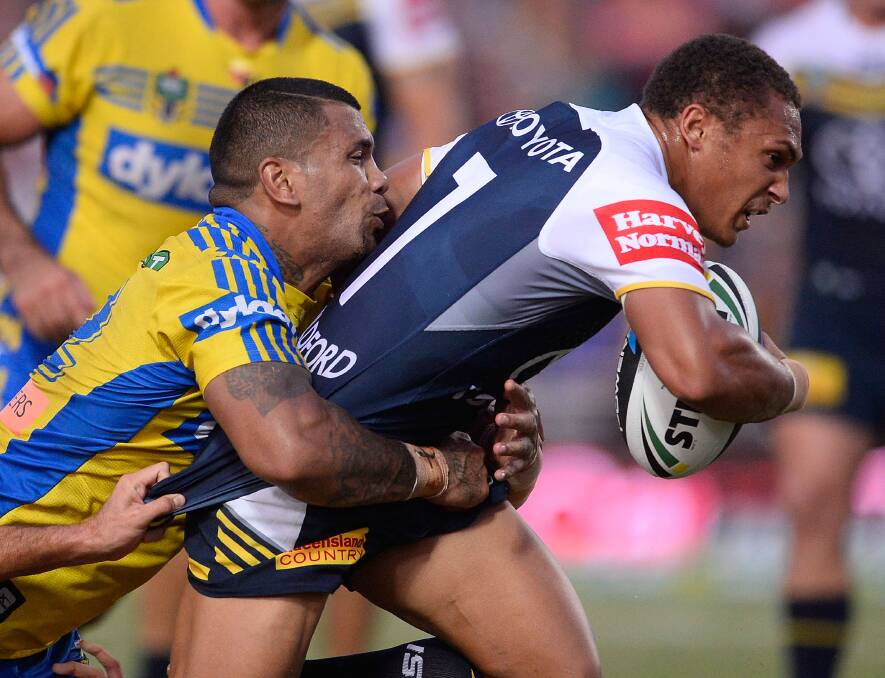 TOWNSVILLE, AUSTRALIA - APRIL 26: Ray Thompson of the Cowboys is tackled by Manu Ma'u of the Eels during the round 8 NRL match between the North Queensland Cowboys and the Parramatta Eels at 1300SMILES Stadium on April 26, 2014 in Townsville, Australia. (Photo by Ian Hitchcock/Getty Images)