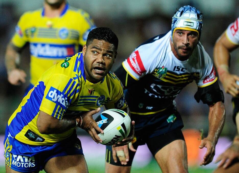 TOWNSVILLE, AUSTRALIA - APRIL 26: Chris Sandow of the Eels looks to get away from Johnathan Thurston of the Cowboys during the round 8 NRL match between the North Queensland Cowboys and the Parramatta Eels at 1300SMILES Stadium on April 26, 2014 in Townsville, Australia. (Photo by Ian Hitchcock/Getty Images)