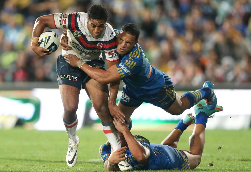 SYDNEY, AUSTRALIA - APRIL 12: Michael Jennings of the Roosters is tackled by Will Hopoate of the Eels during the round 6 NRL match between the Parramatta Eels and the Sydney Roosters at Pirtek Stadium on April 12, 2014 in Sydney, Australia. (Photo by Mark Metcalfe/Getty Images)