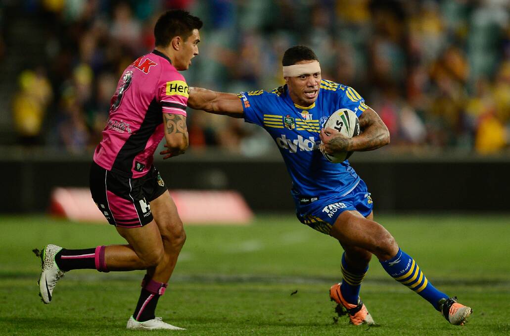 SYDNEY, AUSTRALIA - MARCH 29: Willie Tonga of the Eels palms off Dean Whare of the Panthers during the round four NRL match between the Parramatta Eels and the Penrith Panthers at Pirtek Stadium on March 29, 2014 in Sydney, Australia. (Photo by Brett Hemmings/Getty Images)