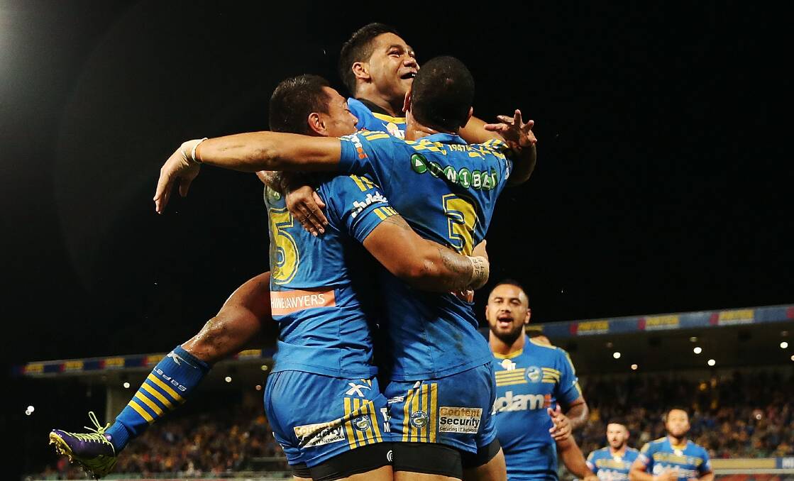 SYDNEY, AUSTRALIA - APRIL 12: Ken Sio of the Eels celebrates with team mate Will Hopoate and Chris Sandow after scoring a try during the round 6 NRL match between the Parramatta Eels and the Sydney Roosters at Pirtek Stadium on April 12, 2014 in Sydney, Australia. (Photo by Mark Metcalfe/Getty Images)