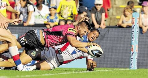 The Newcastle Knights versus The Penrith Panthers at Sportingbet Stadium, Penrith, on March 8. Picture shows Panthers' player Josh Mansour scoring a try in the second half (Knights' player Dane Gagai, bottom right). Picture: Jonathan Carroll