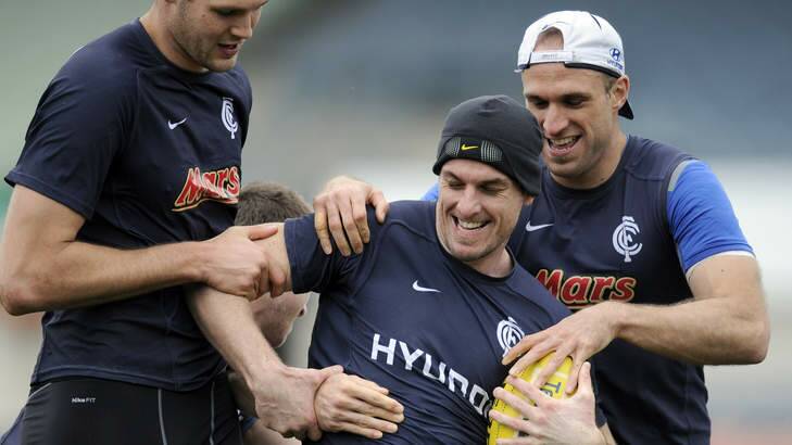 Heath Scotland (centre) will line up for his first pre-season match against Adelaide, but Chris Judd (right) won't be playing. Photo: Sebastian Costanzo
