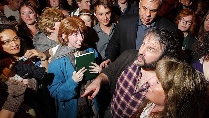 Die hards ... director Peter Jackson, checked shirt, meets fans in Middle Earth costumes at a party in Wellington.