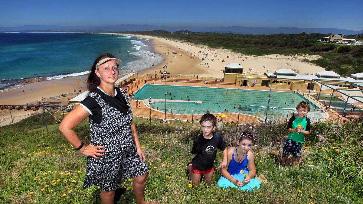 Katherine Pulo with children Lucas and Mitchell, and family friend Aprelle Garcia above Port Kembla pool. Picture: ORLANDO CHIODO