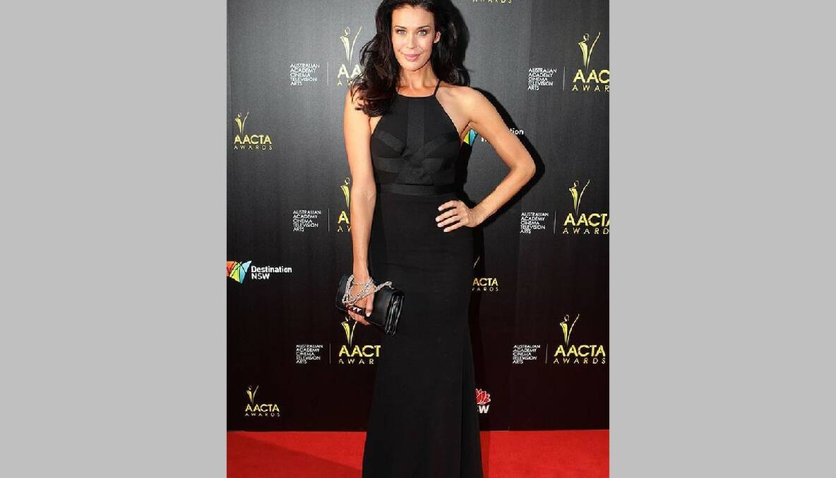 Megan Gale wears Alex Perry and holds a Valentino clutch at the AACTA Awards in Sydney. Photo: Dallas Kilponen