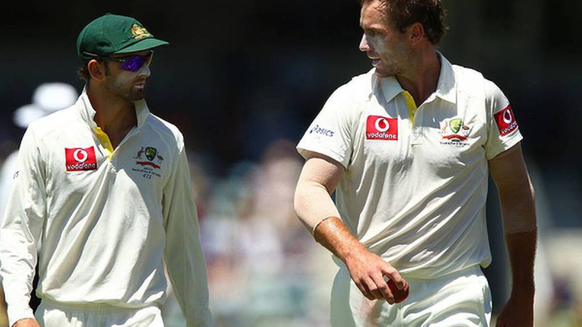 Nathan Lyon of Australia talks with John Hastings during day three of the Third Test Match between Australia and South Africa at WACA Photo: Getty