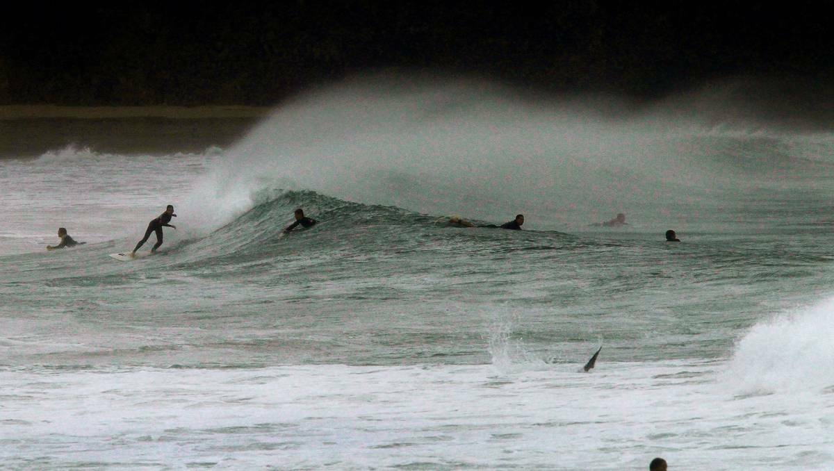 Surfers and body boarders took on big waves on Monday at The Farm, Wollongong. Pictures: SYLVIA LIBER