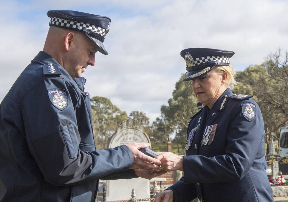 Acting Chief Commissioner Wendy Steendam presents the Victoria Police Star beside Senior Constable Edward Barnett's grave in the Carisbrook Cemetery. Picture: DARREN HOWE