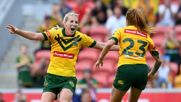 Giant leap for women's rugby league: Ali Brigginshaw, left, and Caitlin Moran celebrate after winning the World Cup last week. Photo: AAP