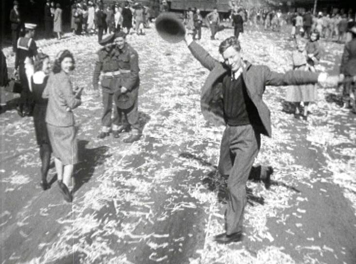 DANCING MAN: This now-famous still from a newsreel features an anonymous man dancing on the street in Sydney, Australia, after the end of WWII. It was featured on a 2005 commemorative $1 coin.