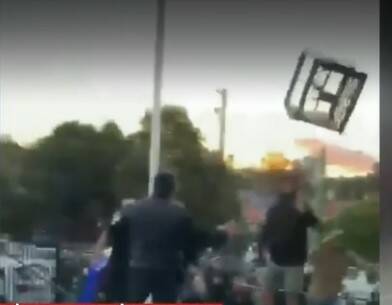 BRAWL: A milk crate flies through the air after being thrown during the brawl. Picture: Facebook.