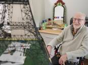 John Oste constructing his Eiffel Tower, with Harbour Bridge in background. Picture by John Veage