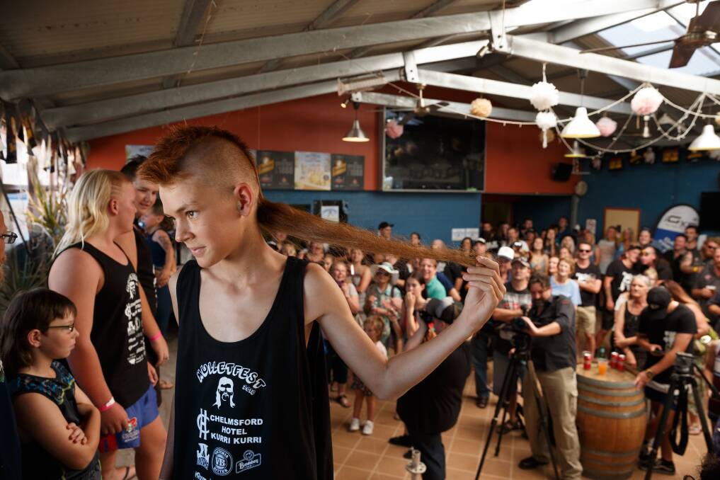 OUTSTANDING: Bailey Robinson from Wollongong, then 13, holds out his hair during judging at the first Mulletfest in February 2018. The event has since gained international notoriety. Pictures: Max Mason-Hubers