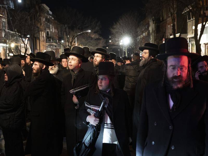 Orthodox Jewish men attend a funeral in Brooklyn for Jersey City shooting victim Moshe Deutsch.