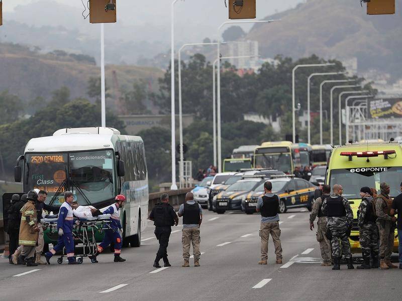 An armed man who hijacked a bus in Rio, holding 37 people hostage, was shot dead by police.