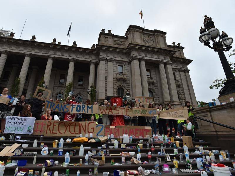 Protesters rubbish the Victorian parliament over the breakdown in the state's recycling system.