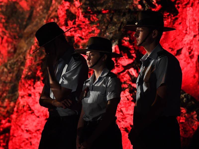 Thousands are at the Anzac Day dawn service at a red-lit Elephant Rock on the Gold Coast.