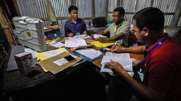 Polling officials at a polling station on the eve of the second phase of the national election. (AP PHOTO)