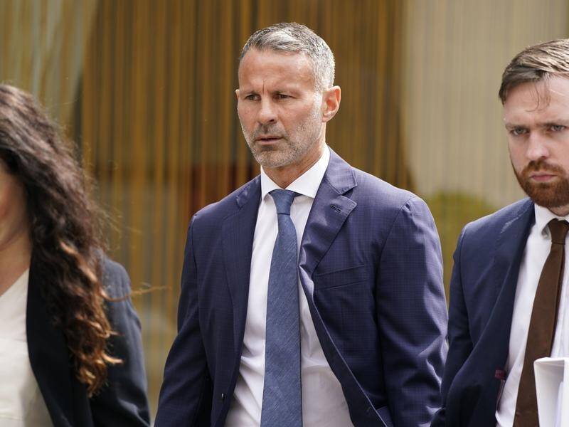 Ryan Giggs (centre) arriving at court where he's charged with, and denies, assaulting two women.